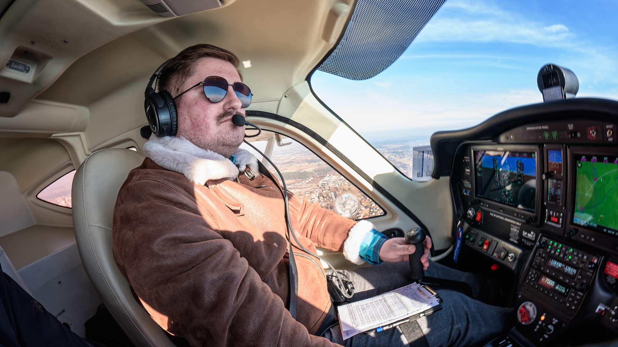 Przemek in the cockpit, flying above the city